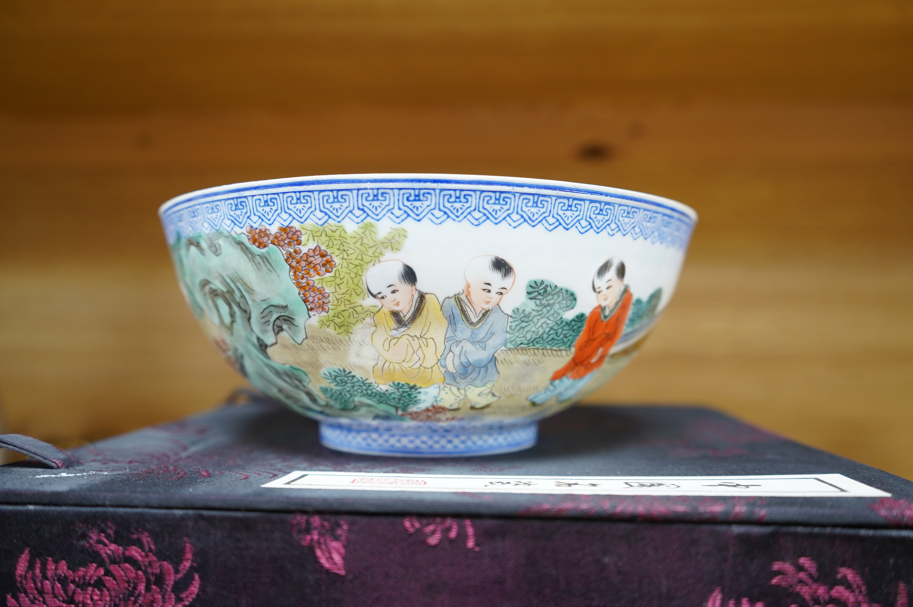 A Chinese eggshell porcelain bowl, 18cm diameter, boxed. Condition - poor, broken and partially repaired